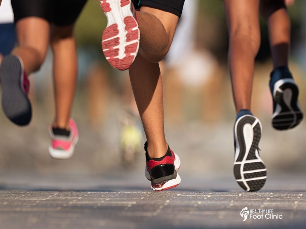 An image of 3 runners running on the pavement