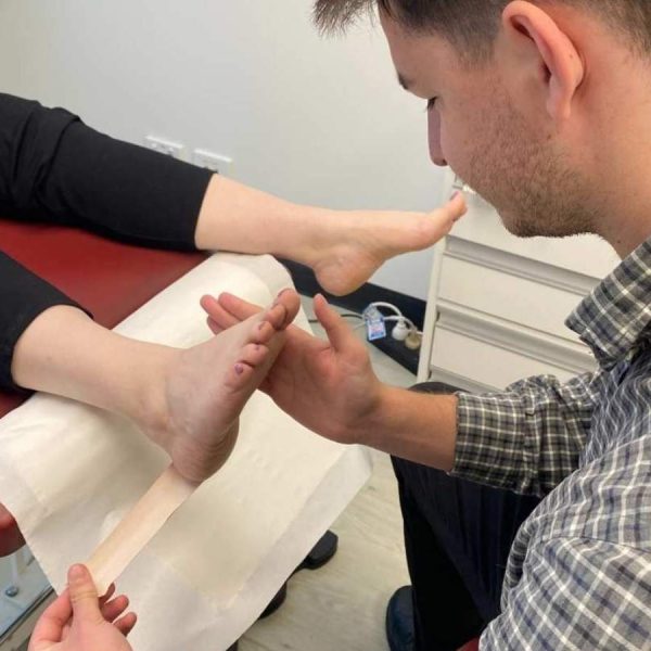 Adelaide Podiatrist providing strapping to foot