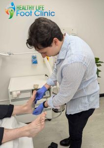 Adelaide Podiatrist, Nick Bourlotos, Reviewing a Patient's Orthotics